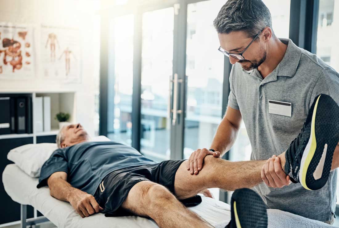 AI image of an elderly man lying on a table while a younger man in glasses gently stretches out his leg
